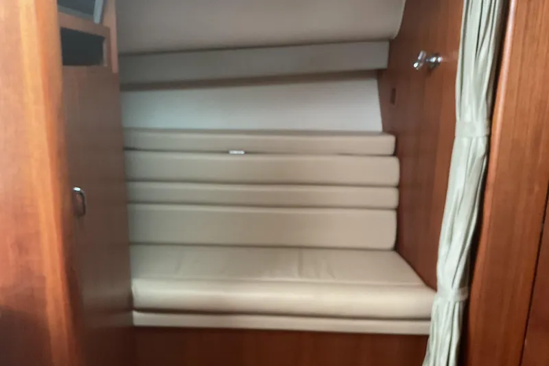 Slide: The Image of 2006 Tiara Yachts 3800 Open galley with sink, wooden cabinetry, and coffee maker. - 5