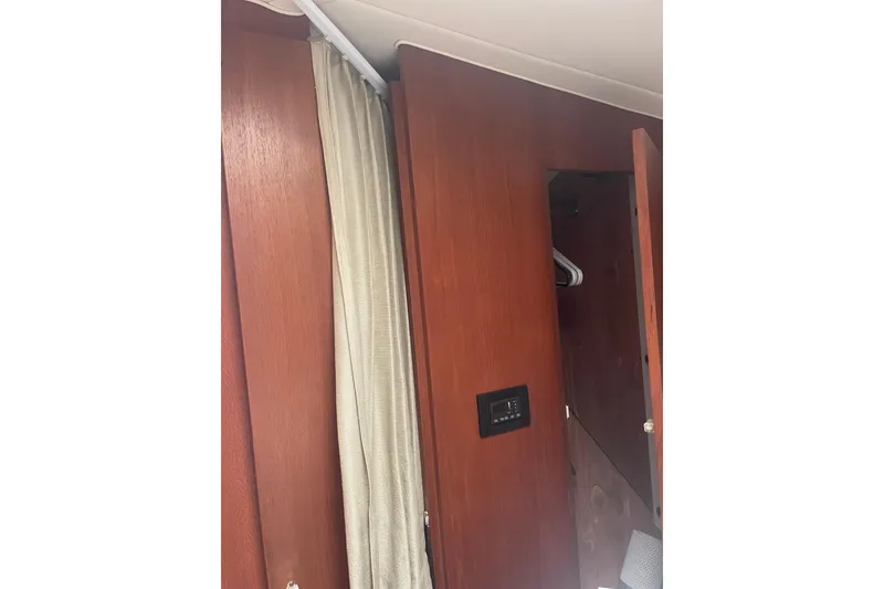 Slide: The Image of Interior of 2006 Tiara Yachts 3800 Open with wooden paneling and curtain. - 9