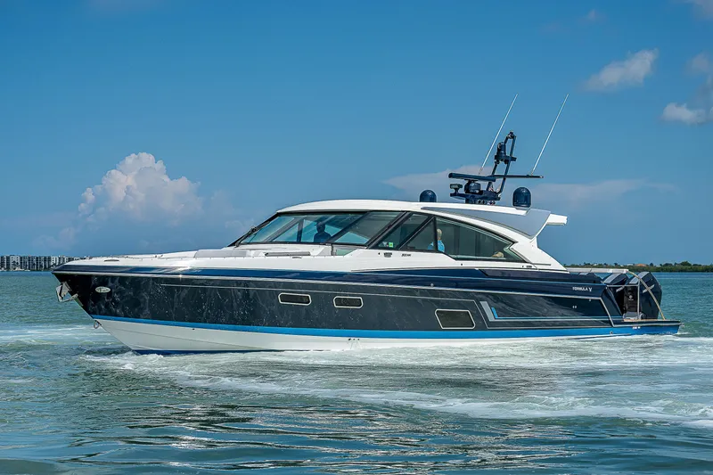 The Image of 2022 Formula 500 Super Sport Crossover cruising on open water under a clear blue sky. - 0