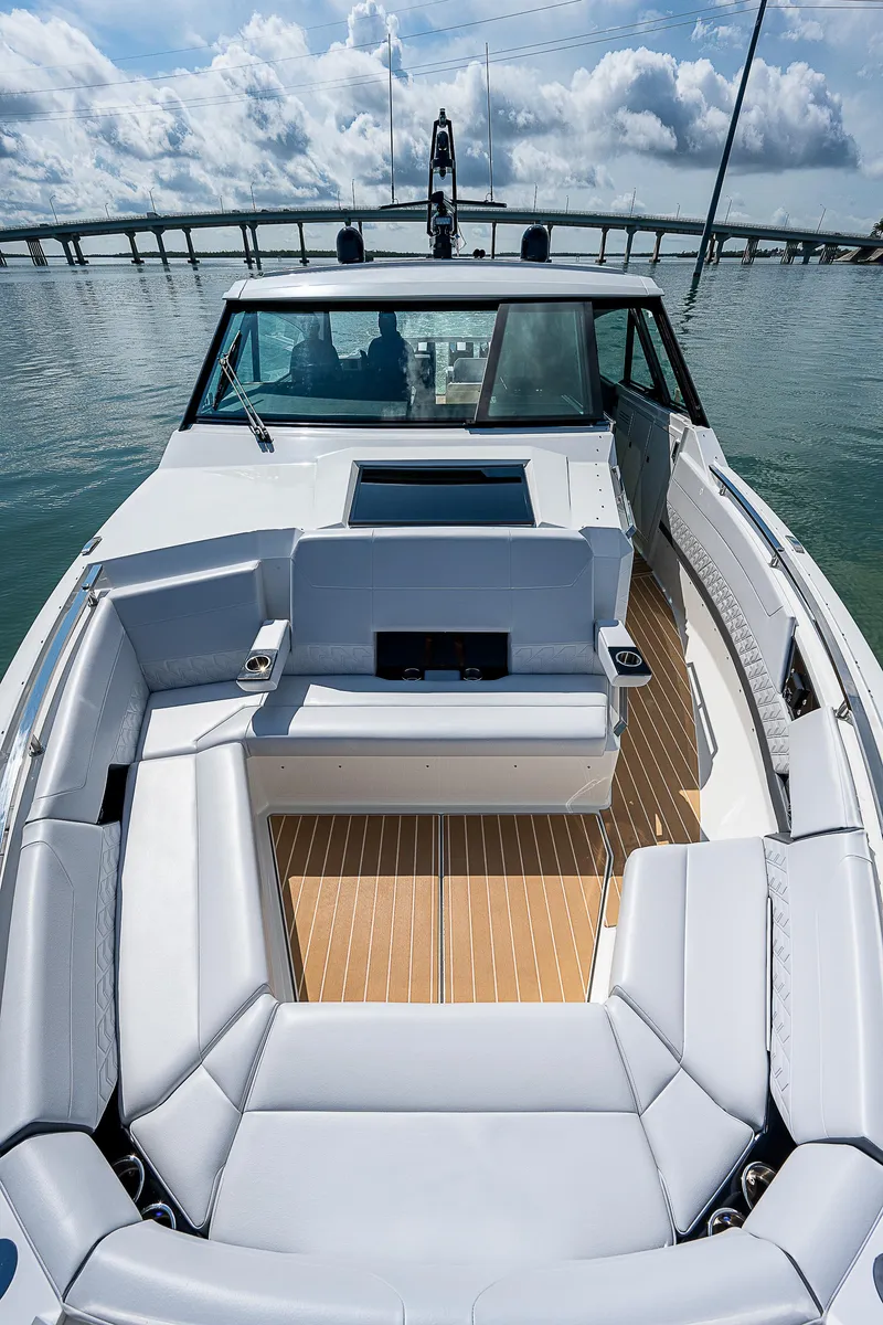 Slide: The Image of 2022 Formula 500 Super Sport Crossover boat with spacious seating on calm water. - 15