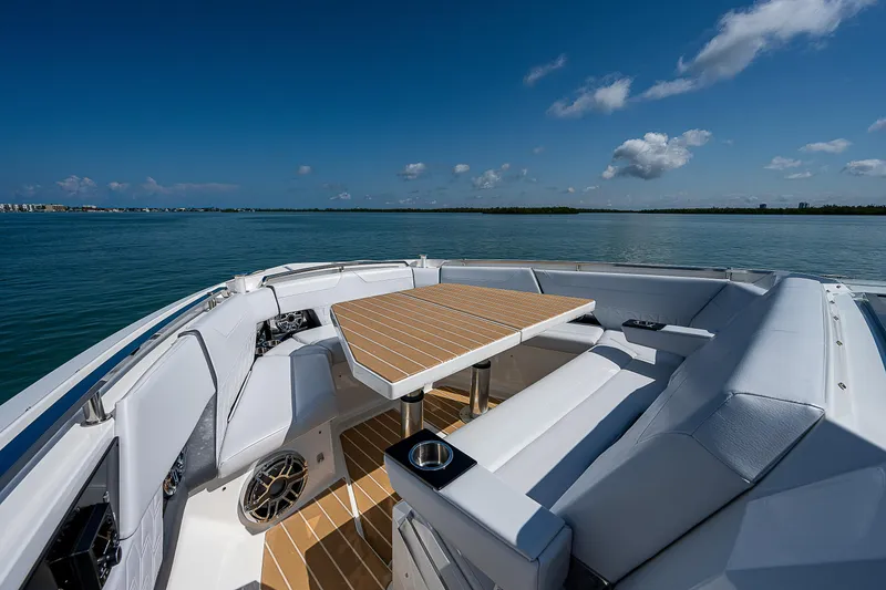 Slide: The Image of 2022 Formula 500 Super Sport Crossover boat interior with seating and table on open water. - 19