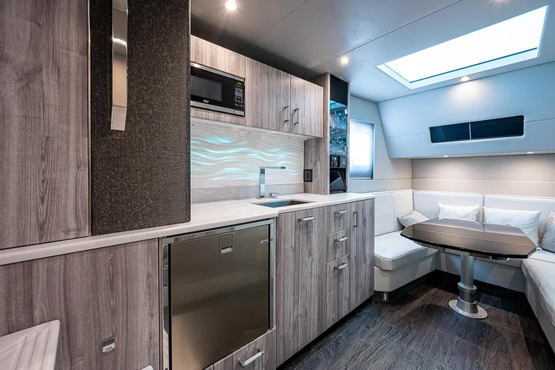 Slide: The Image of Luxurious interior of 2022 Formula 500 Super Sport Crossover yacht with modern kitchen and seating area. - 26