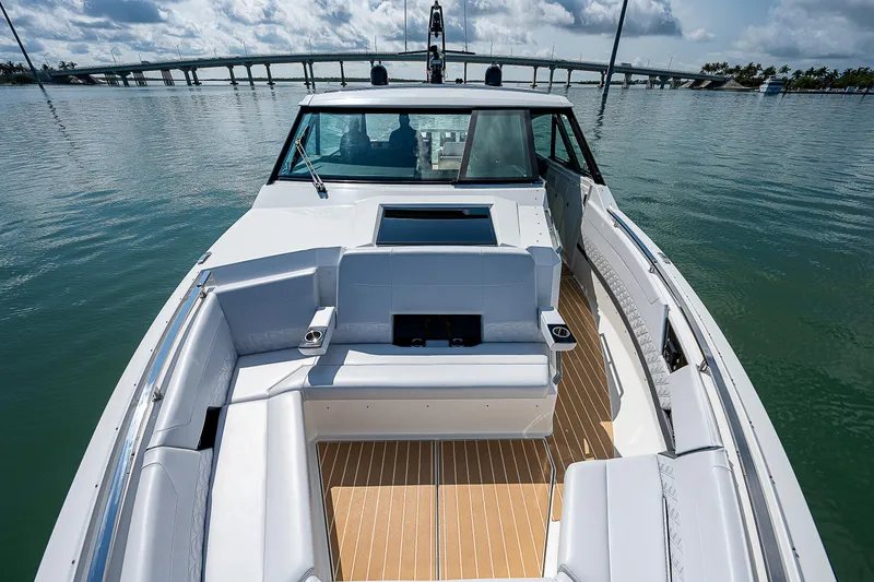 Slide: The Image of 2022 Formula 500 Super Sport Crossover boat with spacious seating on calm water. - 38