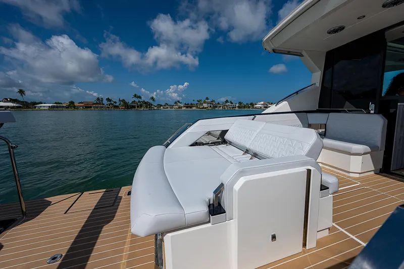 Slide: The Image of Luxury seating on 2022 Formula 500 Super Sport Crossover yacht, docked by scenic waterfront. - 41