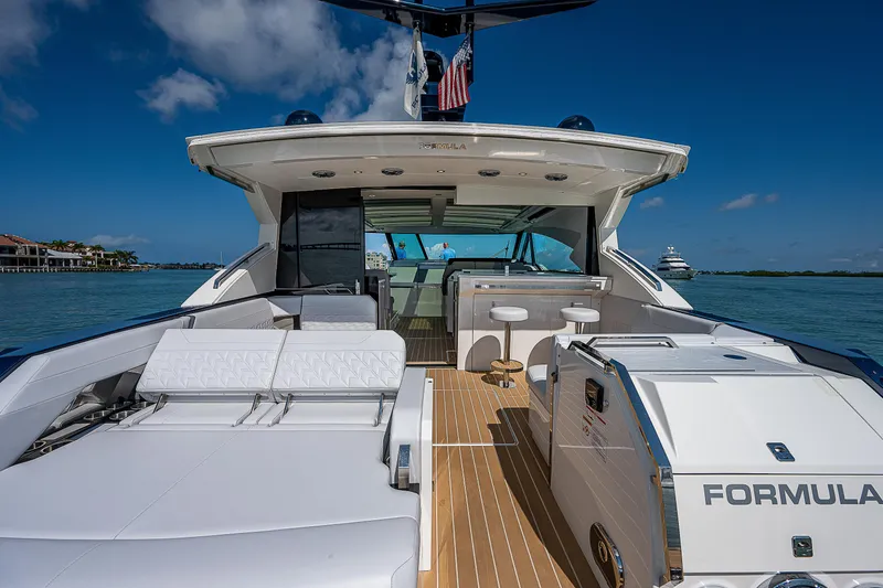 Slide: The Image of 2022 Formula 500 Super Sport Crossover yacht on open water, showcasing luxury deck and seating. - 44
