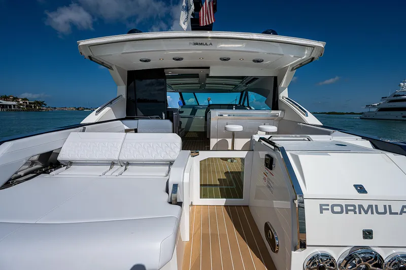 Slide: The Image of 2022 Formula 500 Super Sport Crossover yacht, luxurious deck view, sleek design, open water backdrop. - 48