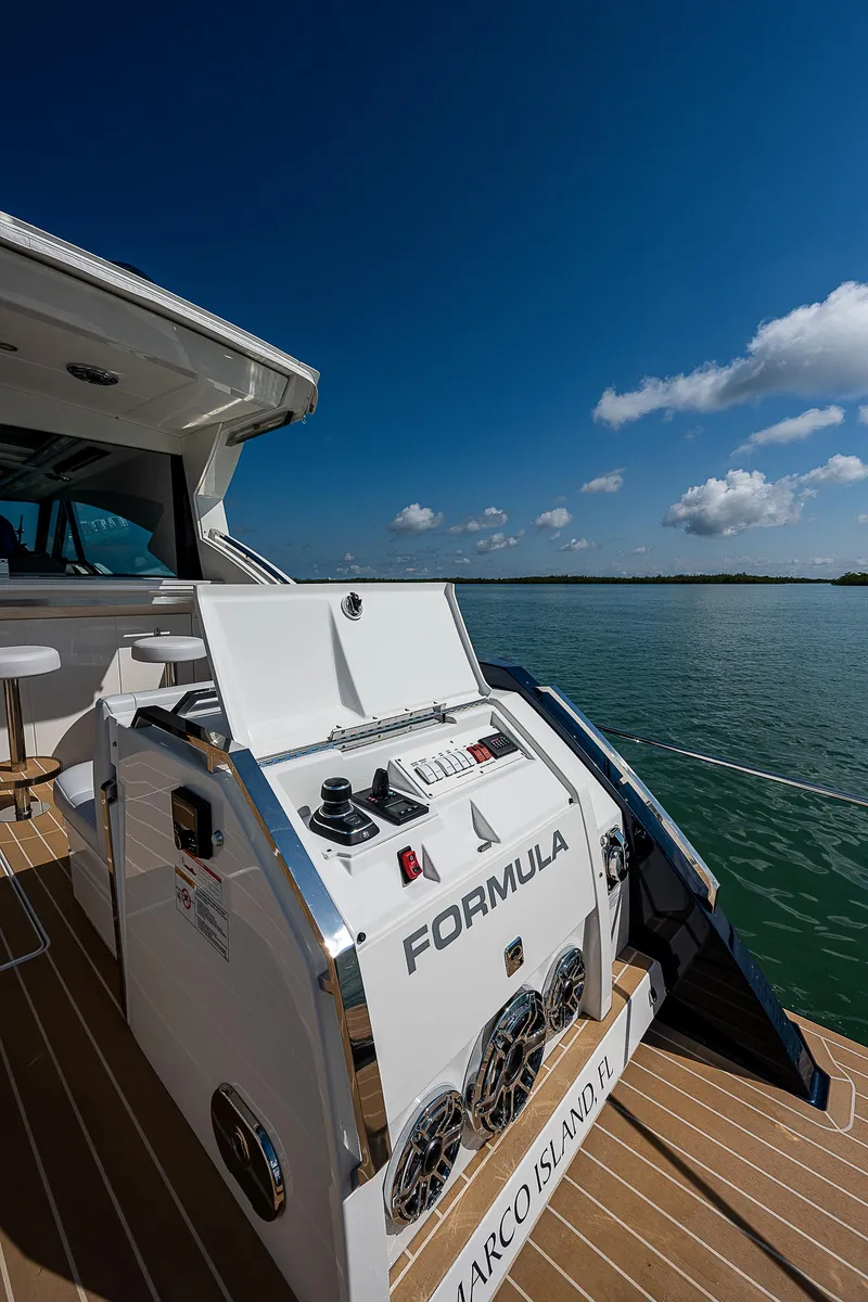 Slide: The Image of 2022 Formula 500 Super Sport Crossover yacht on water under blue sky. - 8