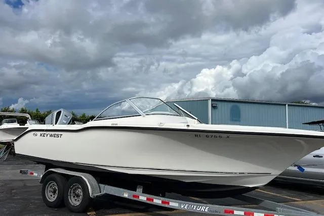 Slide: The Image of 2019 Key West 239 DFS boat on trailer under cloudy sky. - 3