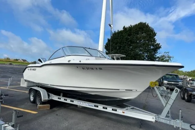 Slide: The Image of 2019 Key West 239 DFS boat on trailer in parking lot, clear sky background. - 7
