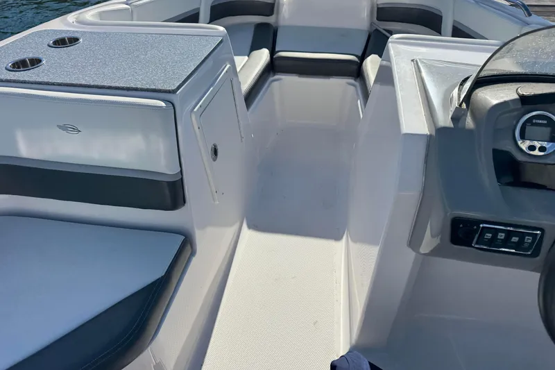 Slide: The Image of 2018 Chaparral 19 SSi Ski & Fish OB interior with seating and dashboard. - 3