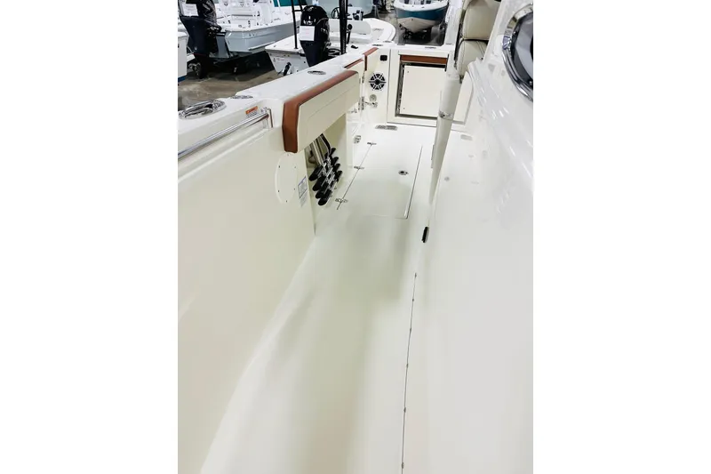 Slide: The Image of 2026 Cobia 265 Center Console boat interior with rod holders and storage compartments. - 13
