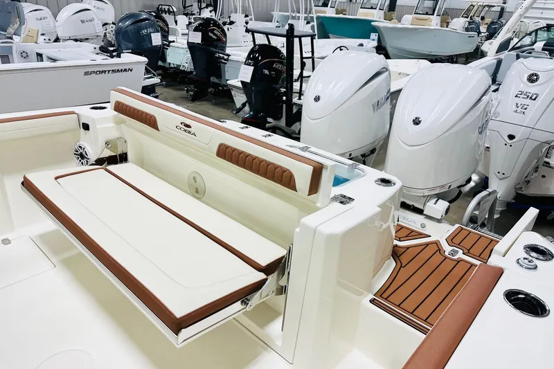 Slide: The Image of 2026 Cobia 265 Center Console boat with Yamaha outboard engines in showroom. - 15