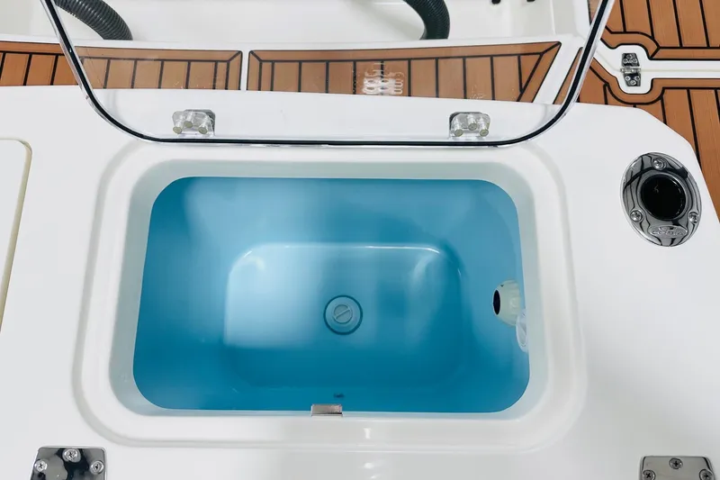 Slide: The Image of Livewell on 2026 Cobia 265 Center Console boat with teak flooring. - 16