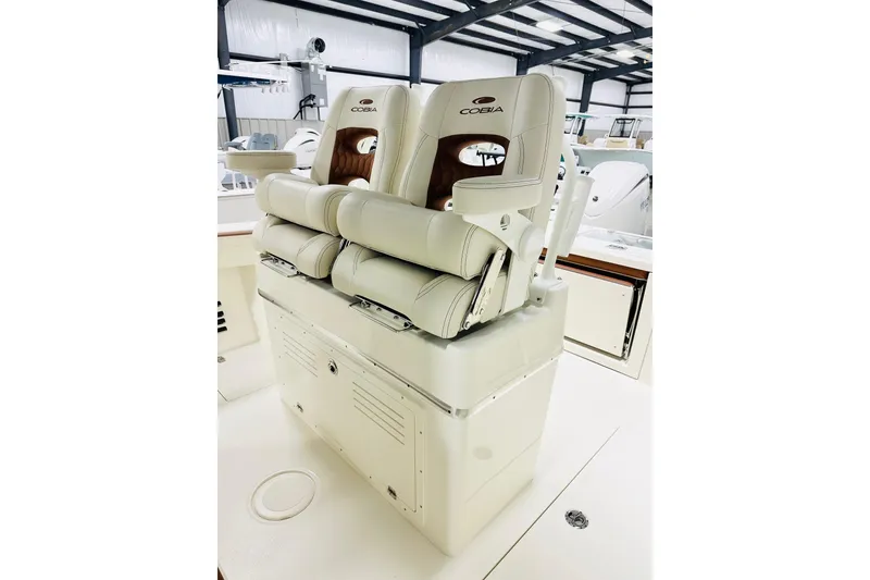 Slide: The Image of 2026 Cobia 265 Center Console boat seats in a showroom. - 4