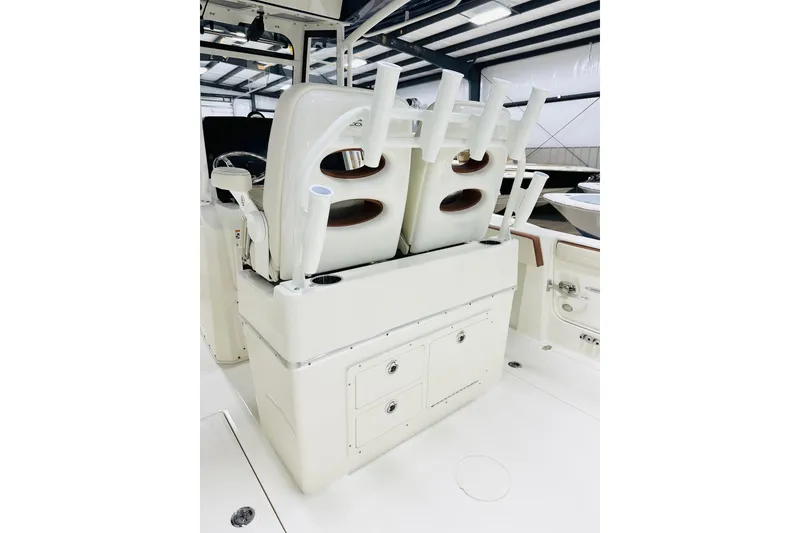 Slide: The Image of 2026 Cobia 265 Center Console boat interior with rod holders and storage compartments. - 5