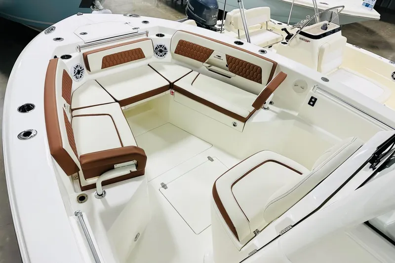 Slide: The Image of 2026 Cobia 265 Center Console boat interior with white and brown seating. - 7