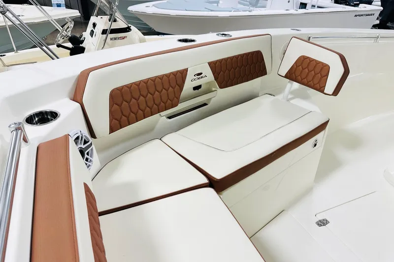 Slide: The Image of 2026 Cobia 265 Center Console boat interior with brown and white seating. - 8