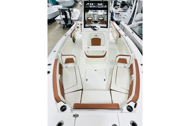 Slide: The Image of 2026 Cobia 265 Center Console boat interior with white and brown seating. - 9