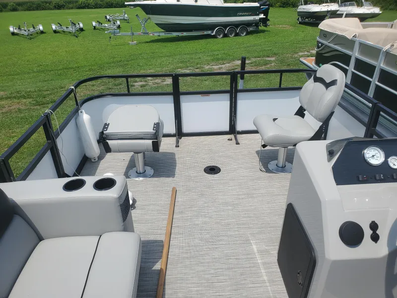 Slide: The Image of 2022 Viaggio Del Mar 16F pontoon boat interior with seating and control panel. - 3