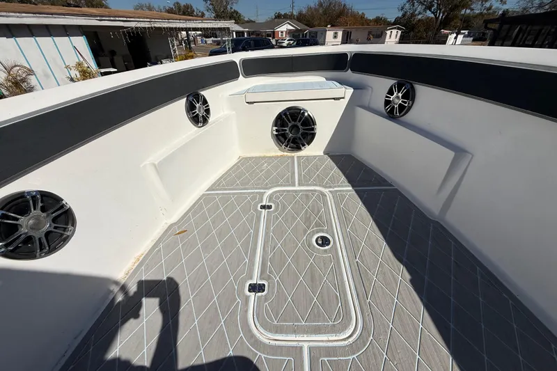 Slide: The Image of 2003 Glasstream 273 SCX boat interior with speakers and patterned flooring. - 105