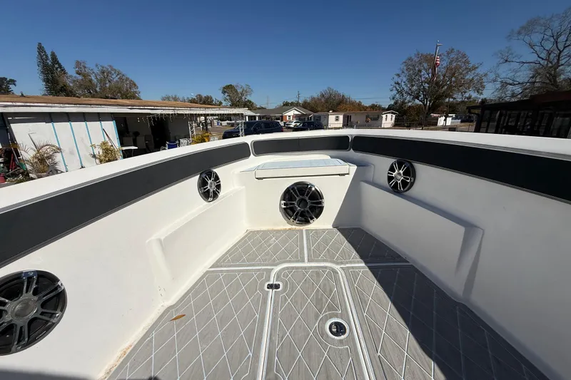 Slide: The Image of 2003 Glasstream 273 SCX boat interior with speakers and seating, outdoor setting. - 106