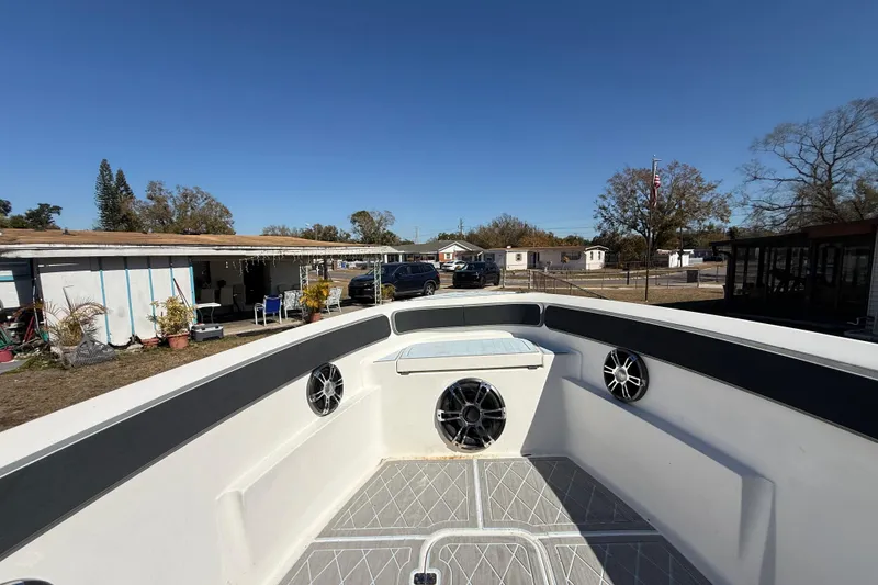 Slide: The Image of 2003 Glasstream 273 SCX boat interior with speakers, outdoor setting in background. - 107