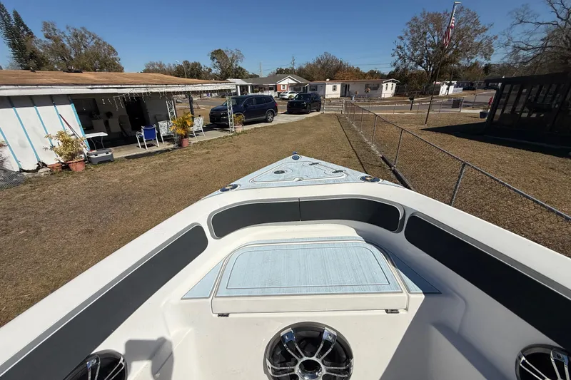 Slide: The Image of 2003 Glasstream 273 SCX boat parked in a residential yard, sunny day. - 109