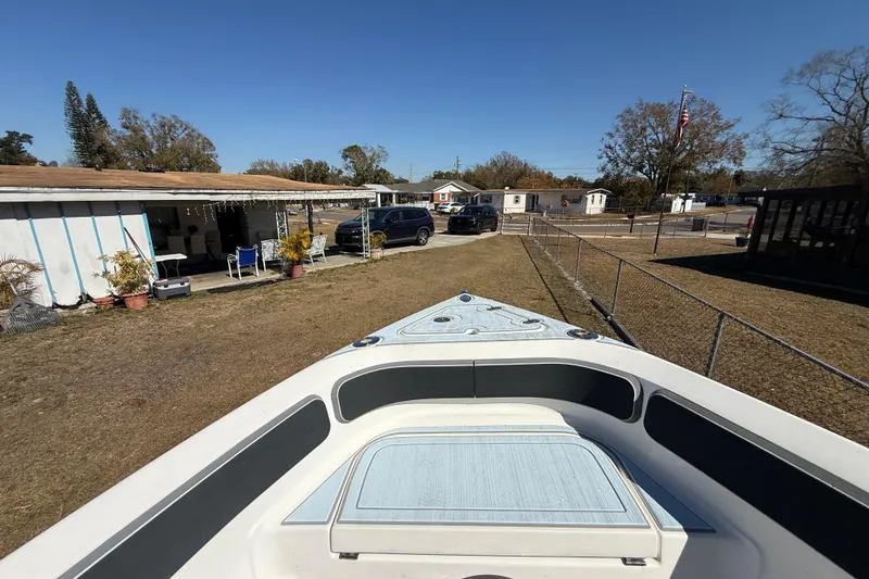 Slide: The Image of 2003 Glasstream 273 SCX boat parked in a residential backyard, sunny day. - 110