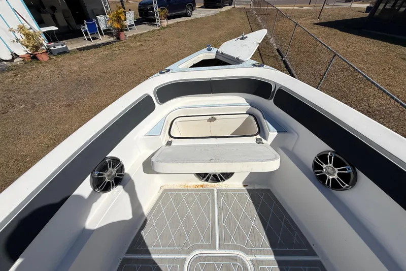 Slide: The Image of 2003 Glasstream 273 SCX boat interior with open storage compartment and speakers. - 111