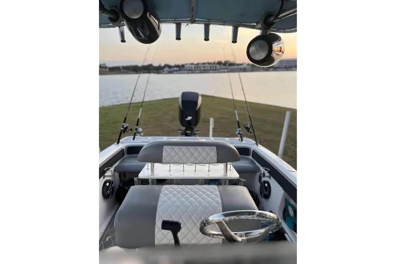 Slide: The Image of 2003 Glasstream 273 SCX boat on trailer in a yard, sunny day. - 12