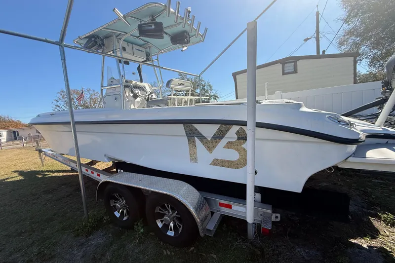 Slide: The Image of 2003 Glasstream 273 SCX boat on trailer, parked outdoors under a clear sky. - 123