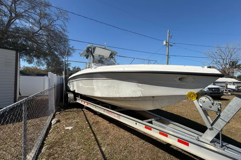 Slide: The Image of 2003 Glasstream 273 SCX boat on trailer, parked outdoors under clear blue sky. - 125