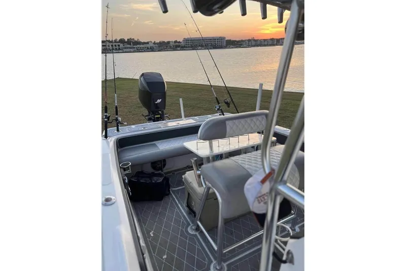 Slide: The Image of 2003 Glasstream 273 SCX boat on trailer in fenced yard, sunny day. - 13