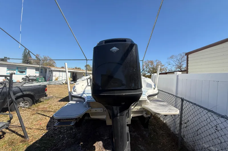 Slide: The Image of 2003 Glasstream 273 SCX boat with outboard motor in a yard setting. - 22