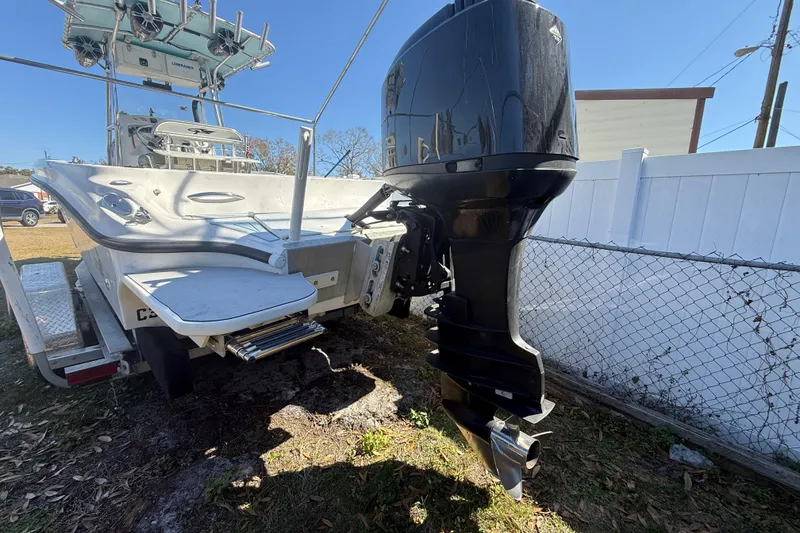 Slide: The Image of 2003 Glasstream 273 SCX boat with powerful outboard motor, parked on a trailer. - 26