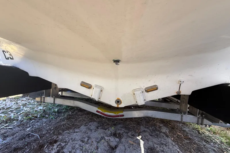 Slide: The Image of 2003 Glasstream 273 SCX boat hull on trailer, showing underside details. - 32
