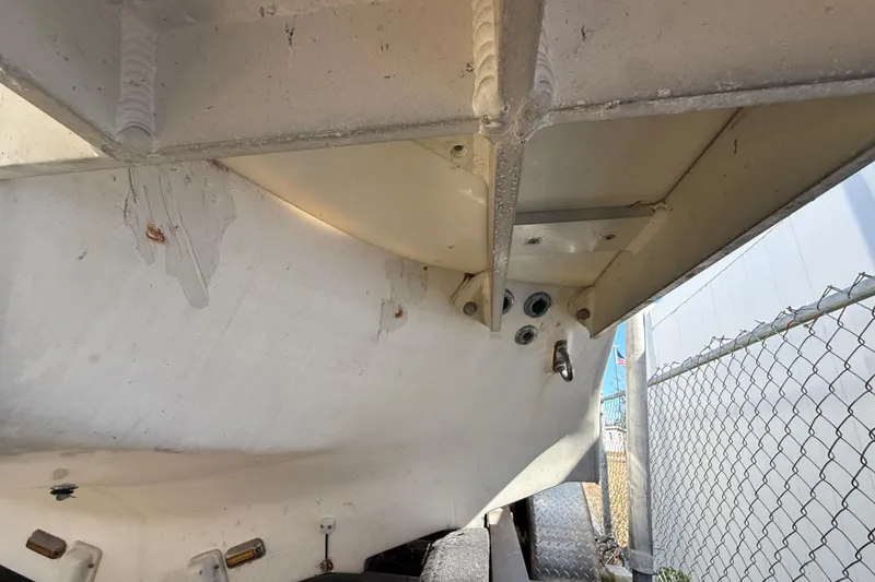 Slide: The Image of 2003 Glasstream 273 SCX boat hull underside, showing structural details and wear. - 33