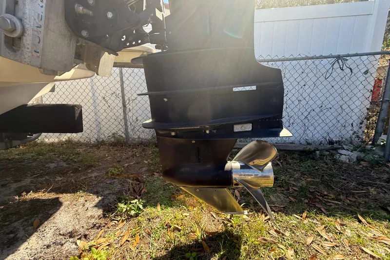 Slide: The Image of Outboard motor of 2003 Glasstream 273 SCX boat, sunlight and fence background. - 36