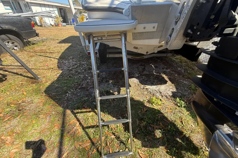 Slide: The Image of Rear view of 2003 Glasstream 273 SCX boat with extended ladder on grass. - 39