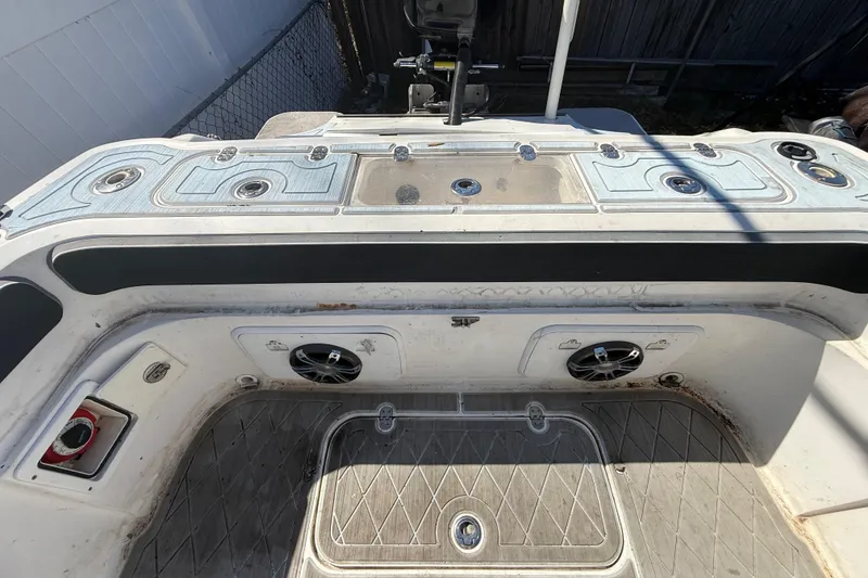 Slide: The Image of 2003 Glasstream 273 SCX boat deck with speakers and storage compartments. - 55
