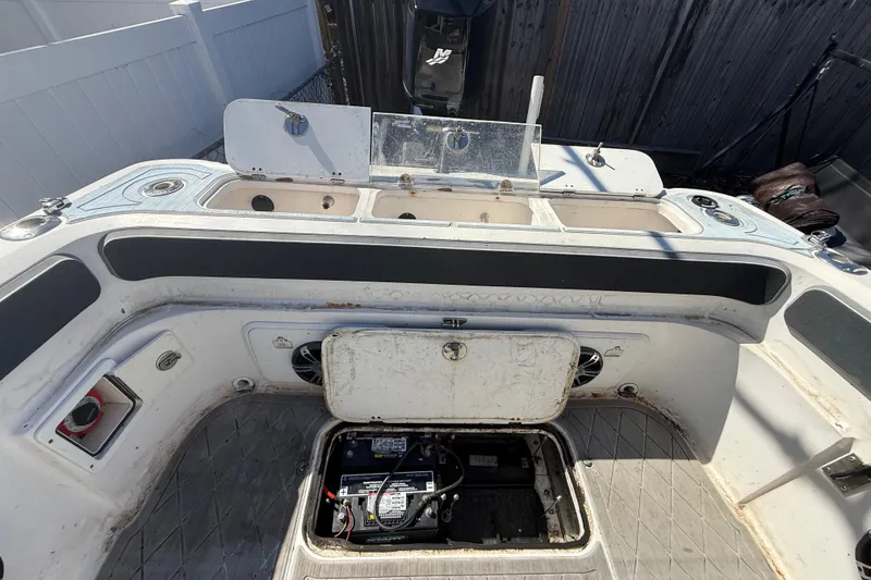 Slide: The Image of 2003 Glasstream 273 SCX boat interior with open battery compartment and control panel. - 61