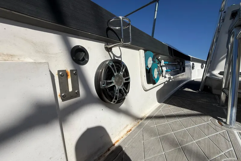 Slide: The Image of 2003 Glasstream 273 SCX boat interior with speaker and fishing rod holders. - 67