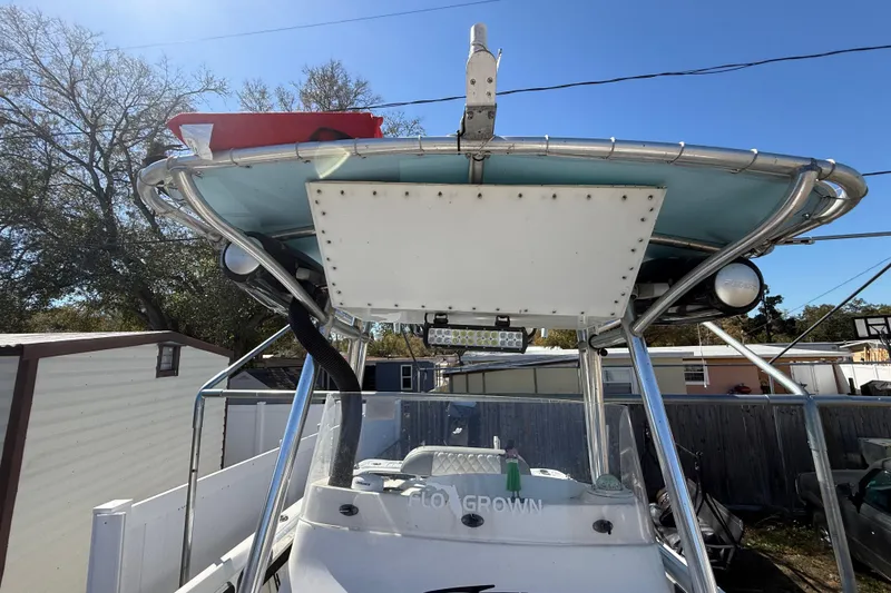 Slide: The Image of 2003 Glasstream 273 SCX boat with T-top and equipment, parked outdoors. - 72