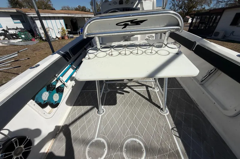 Slide: The Image of 2003 Glasstream 273 SCX boat interior with rod holders and seating area. - 74