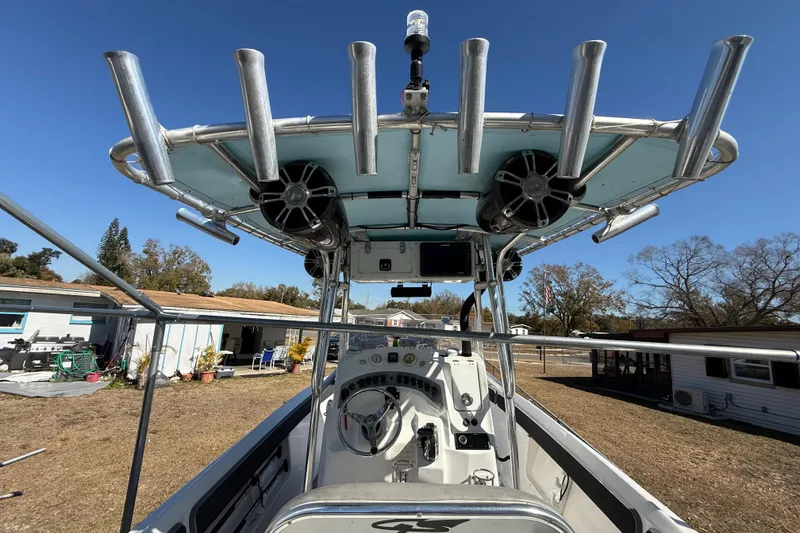 Slide: The Image of 2003 Glasstream 273 SCX boat interior with steering console and rod holders. - 79