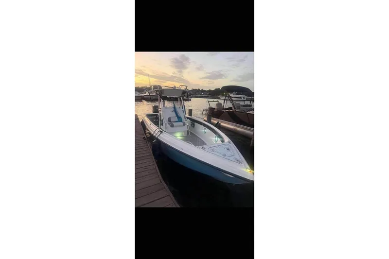 Slide: The Image of Trailer with 2003 Glasstream 273 SCX boat parked on grass near a house. - 9