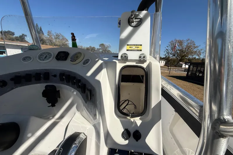 Slide: The Image of 2003 Glasstream 273 SCX boat dashboard with gauges and controls in sunlight. - 95