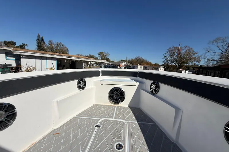 Slide: The Image of 2003 Glasstream 273 SCX boat interior with speakers and seating, under clear blue sky. - 97