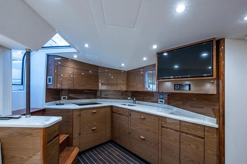 Slide: The Image of Luxurious interior of 2023 Viking 48 Sport Tower yacht with modern kitchen and TV. - 10