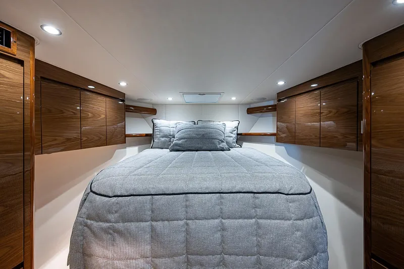 Slide: The Image of Luxurious cabin interior of 2023 Viking 48 Sport Tower yacht with elegant wood finishes. - 16